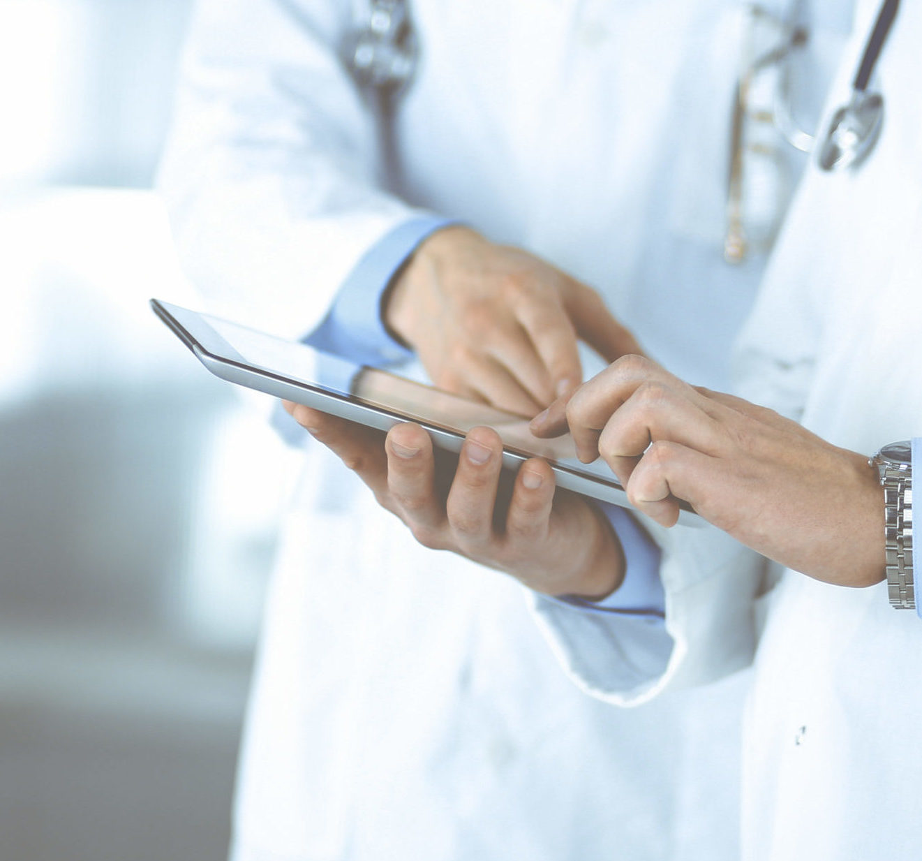 Group Of Unknown Doctors Use A Computer Tablet To Check Up Some citiscan result hand ok
